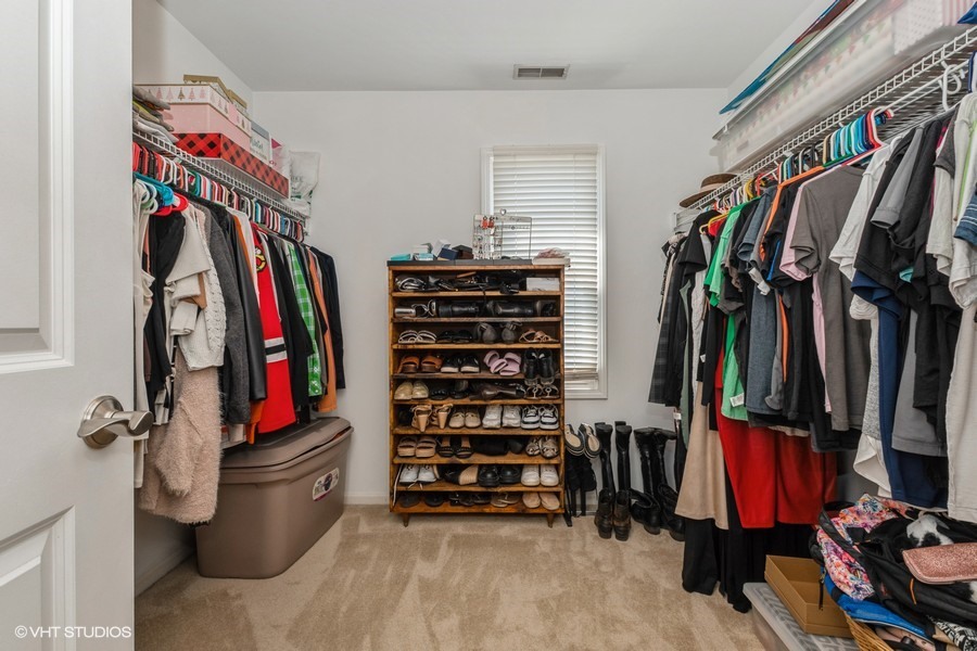13350 Forest Ridge Drive, Unit 2 Palos Heights, IL 60463 - Photo 10 of 13 a view of walk in closet with clothes and shoes