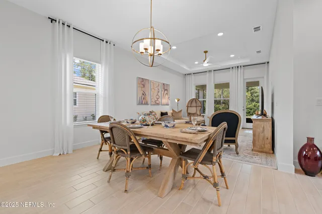 an aerial view of a tennis ground and a cars park side of the road
