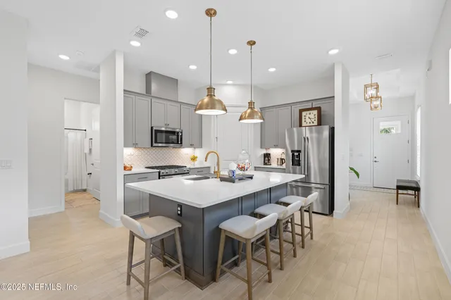 a bathroom with a double vanity sink a mirror a shower and vanity