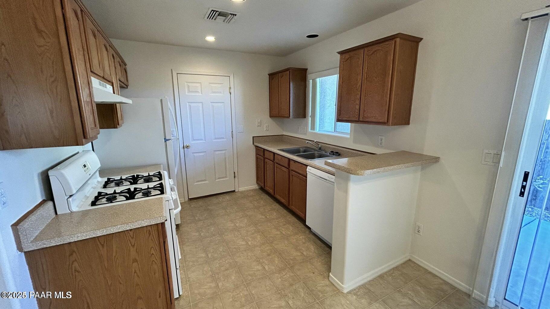 3101 North Corrine Drive, Unit 1 Prescott Valley, AZ 86314 - Photo 11 of 16 a kitchen with a stove and a refrigerator