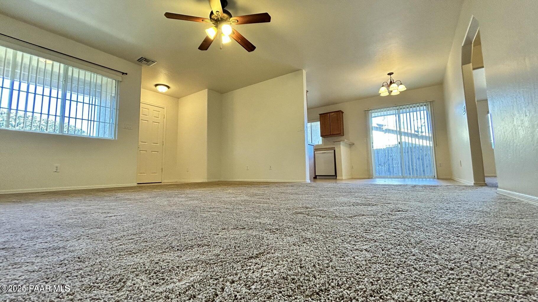 3101 North Corrine Drive, Unit 1 Prescott Valley, AZ 86314 - Photo 3 of 16 a view of a livingroom with a chandelier fan and a window