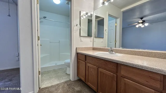 a bathroom with a double vanity sink toilet and shower