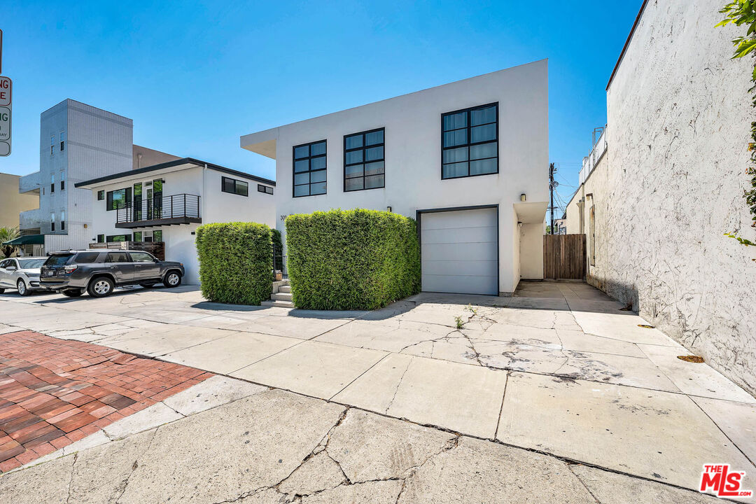 309 South Hamel Road Los Angeles, CA 90048 - Photo 1 of 34 a front view of a house with a yard