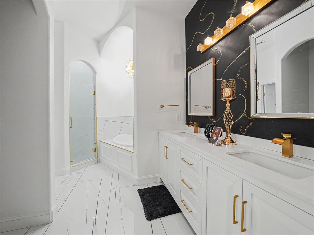 6701 Nauert Road Forest Hill, TX 76140 - Photo 21 of 40 Dual vanity with white cabinetry, gold hardware, and integrated sinks