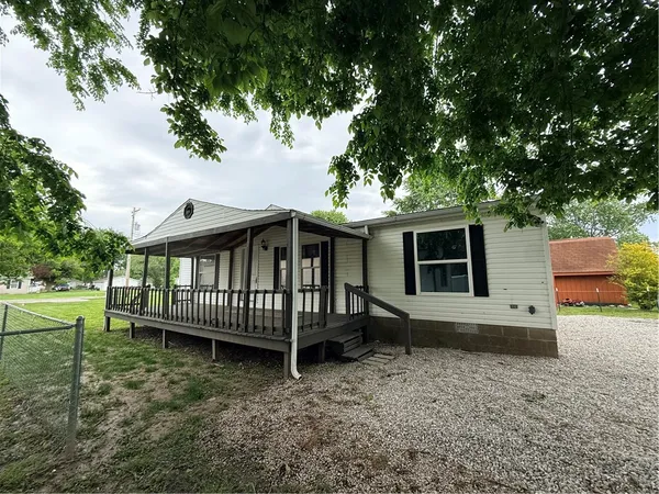 a view of a house with a yard porch and furniture