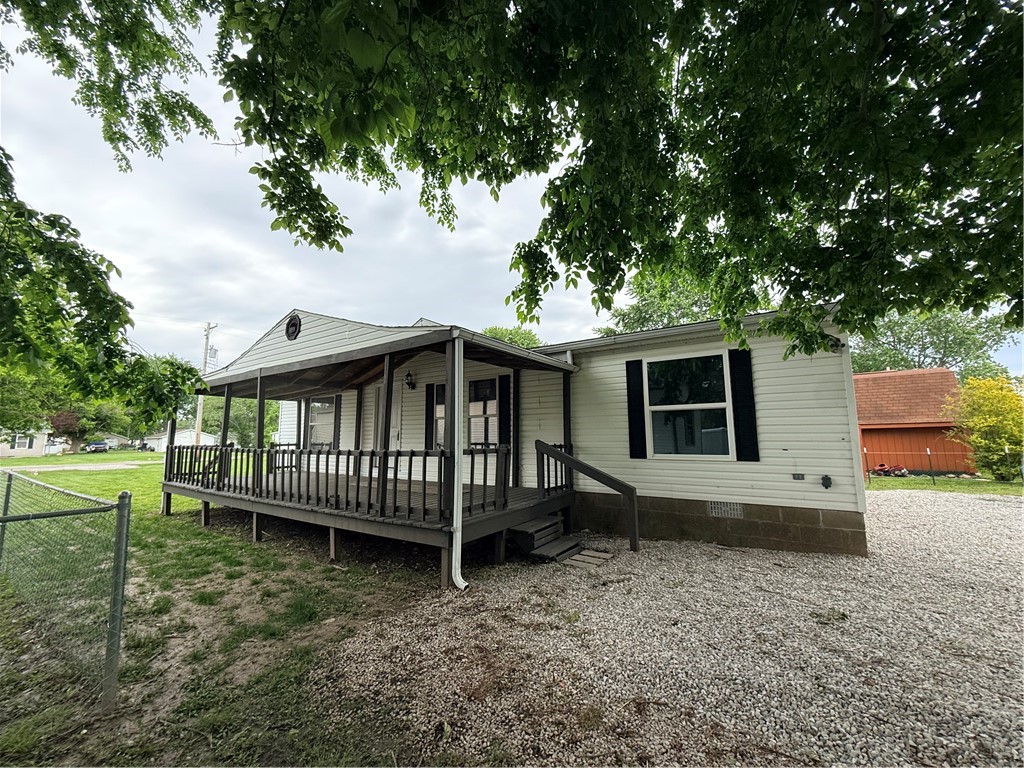 a view of a house with a yard porch and furniture