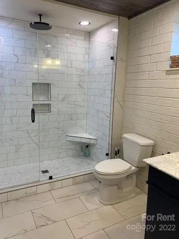 a view of a workspace with furniture and mirror