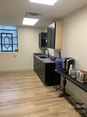 a living room with furniture and paintings on the wall