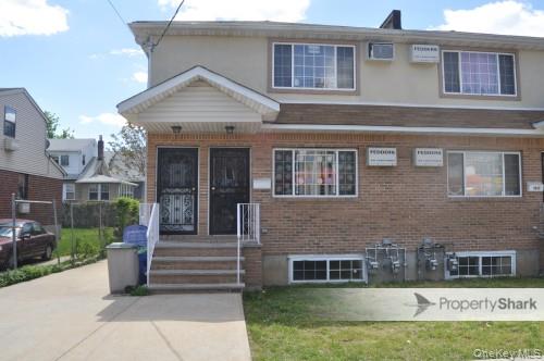 118-36 Guy R Brewer Boulevard, Unit 2 Queens, NY 11434 - Photo 1 of 1 a front view of a house with a yard