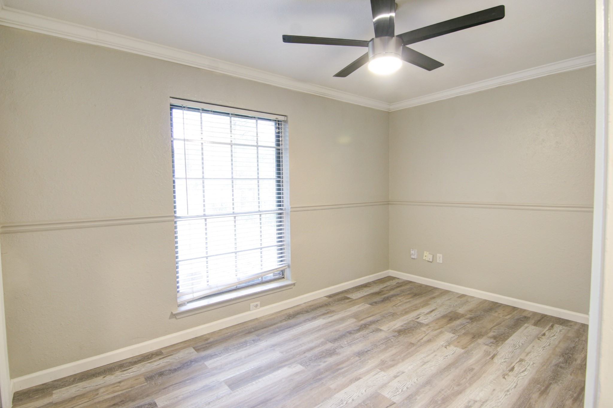 908 Echo Lane Austin, TX 78745 - Photo 11 of 24 a view of empty room with wooden floor and fan