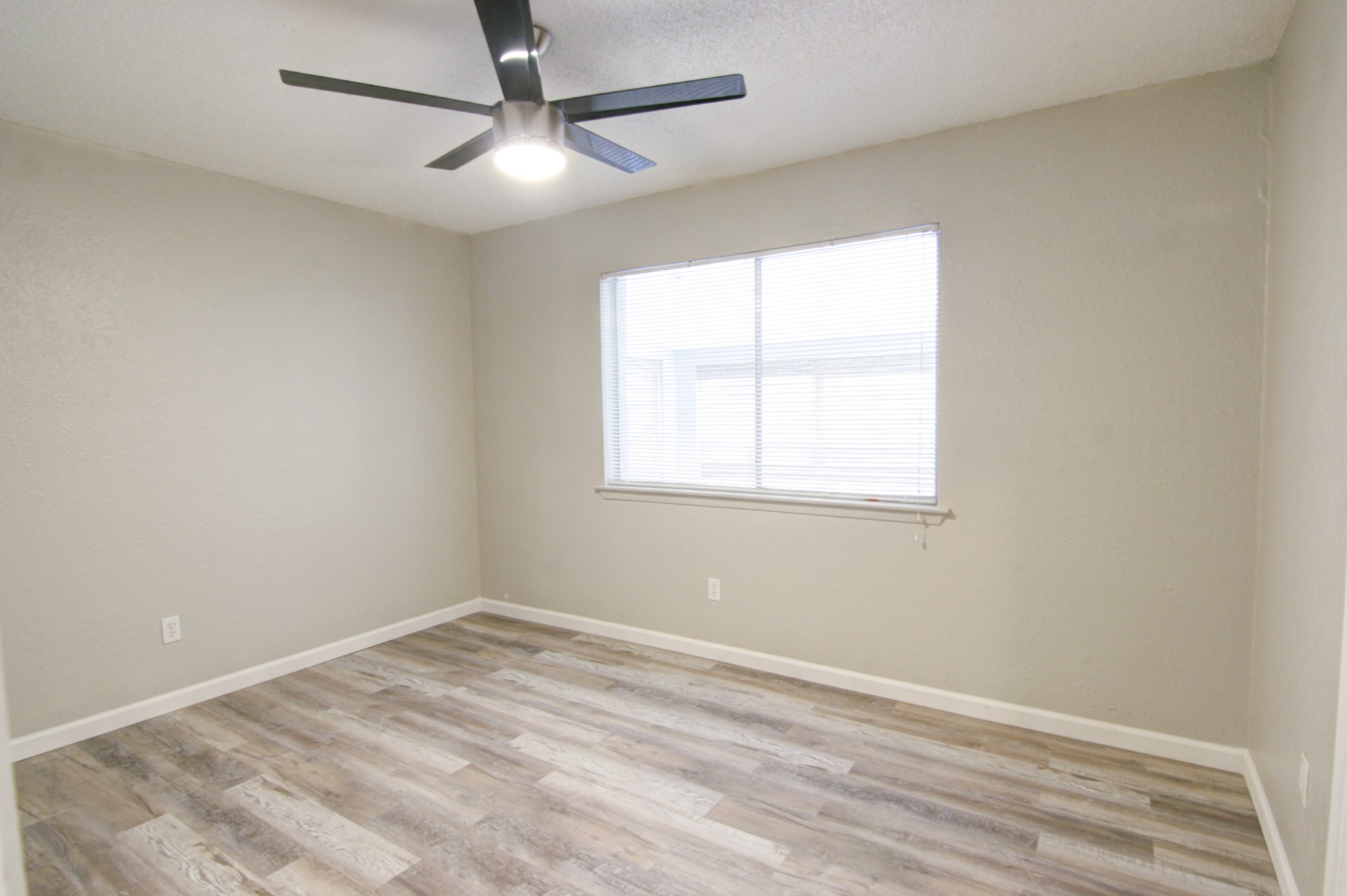 908 Echo Lane Austin, TX 78745 - Photo 14 of 24 an empty room with a window and a fan