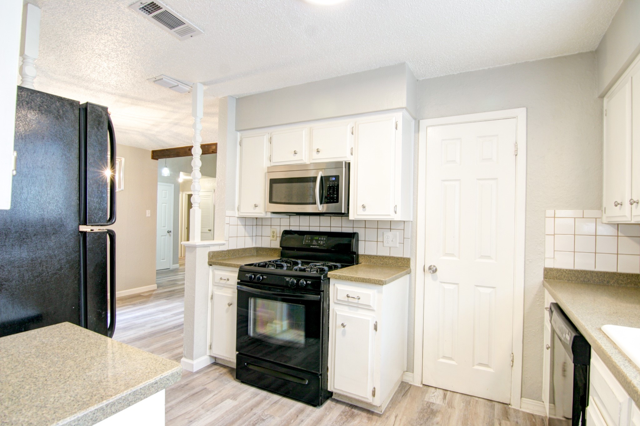 908 Echo Lane Austin, TX 78745 - Photo 17 of 24 a kitchen with a refrigerator stove and cabinets