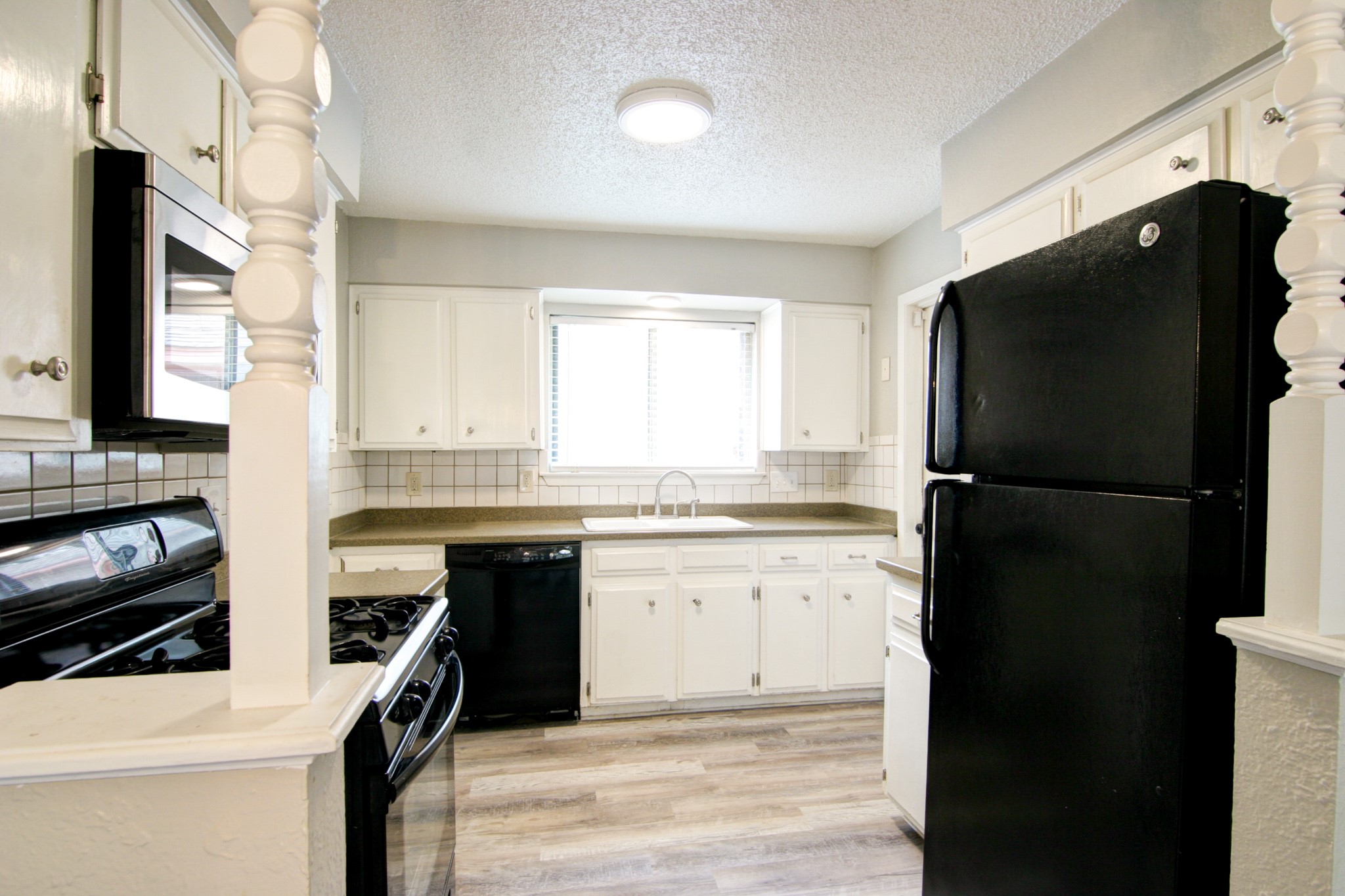 908 Echo Lane Austin, TX 78745 - Photo 18 of 24 a kitchen with a refrigerator stove and sink