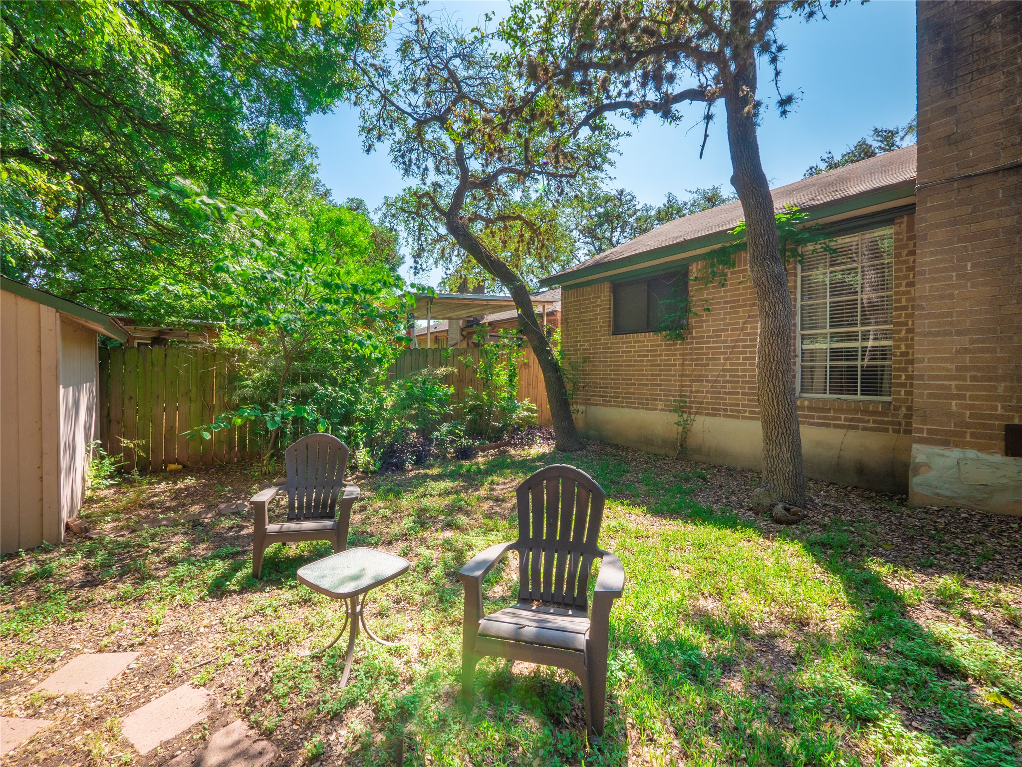 908 Echo Lane Austin, TX 78745 - Photo 23 of 24 a backyard of a house with yard and outdoor seating