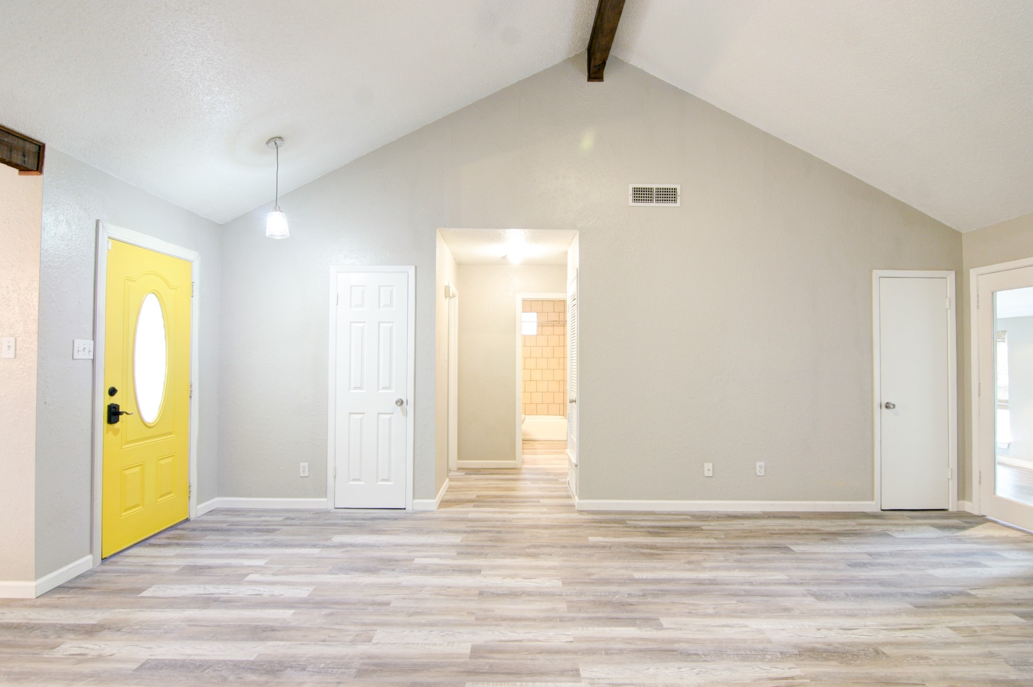 908 Echo Lane Austin, TX 78745 - Photo 4 of 24 a view of a room with wooden floor and windows