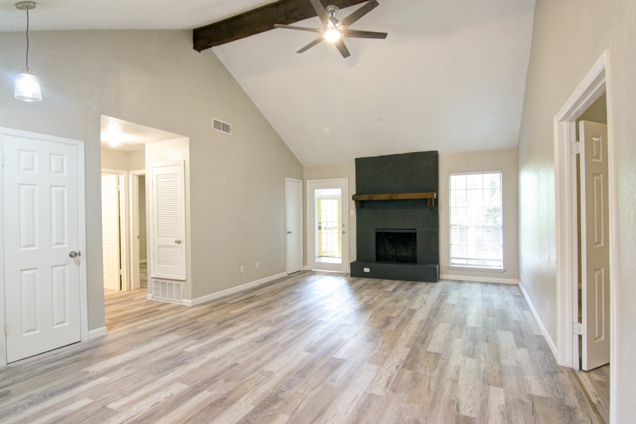 908 Echo Lane Austin, TX 78745 - Photo 6 of 24 a view of a livingroom with a fireplace a ceiling fan and window