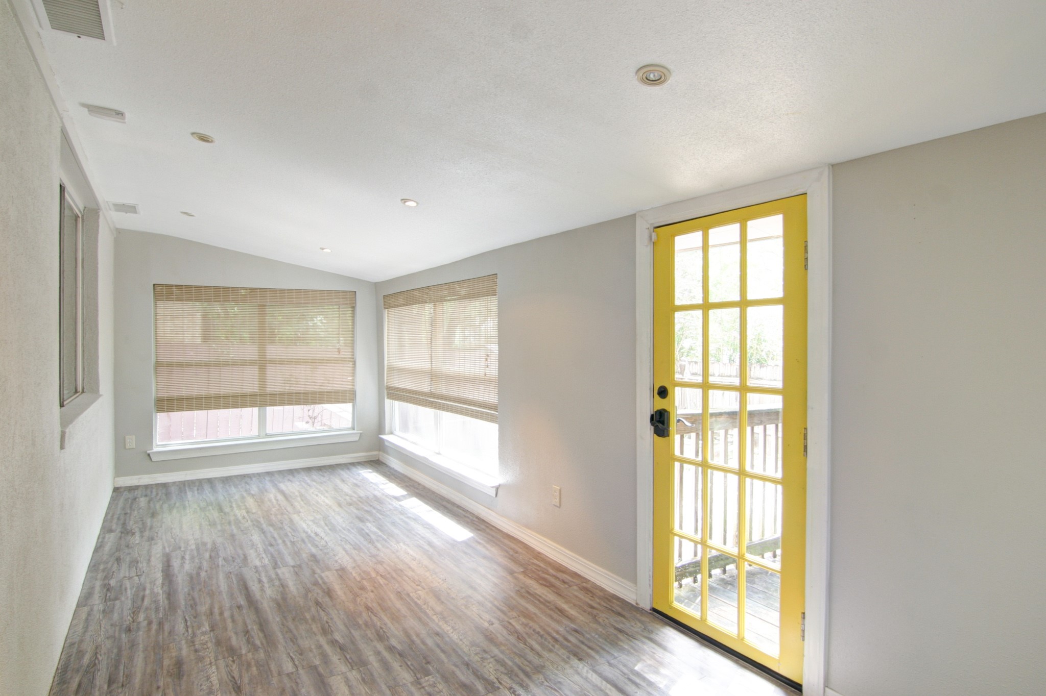 908 Echo Lane Austin, TX 78745 - Photo 9 of 24 an empty room with wooden floor and windows