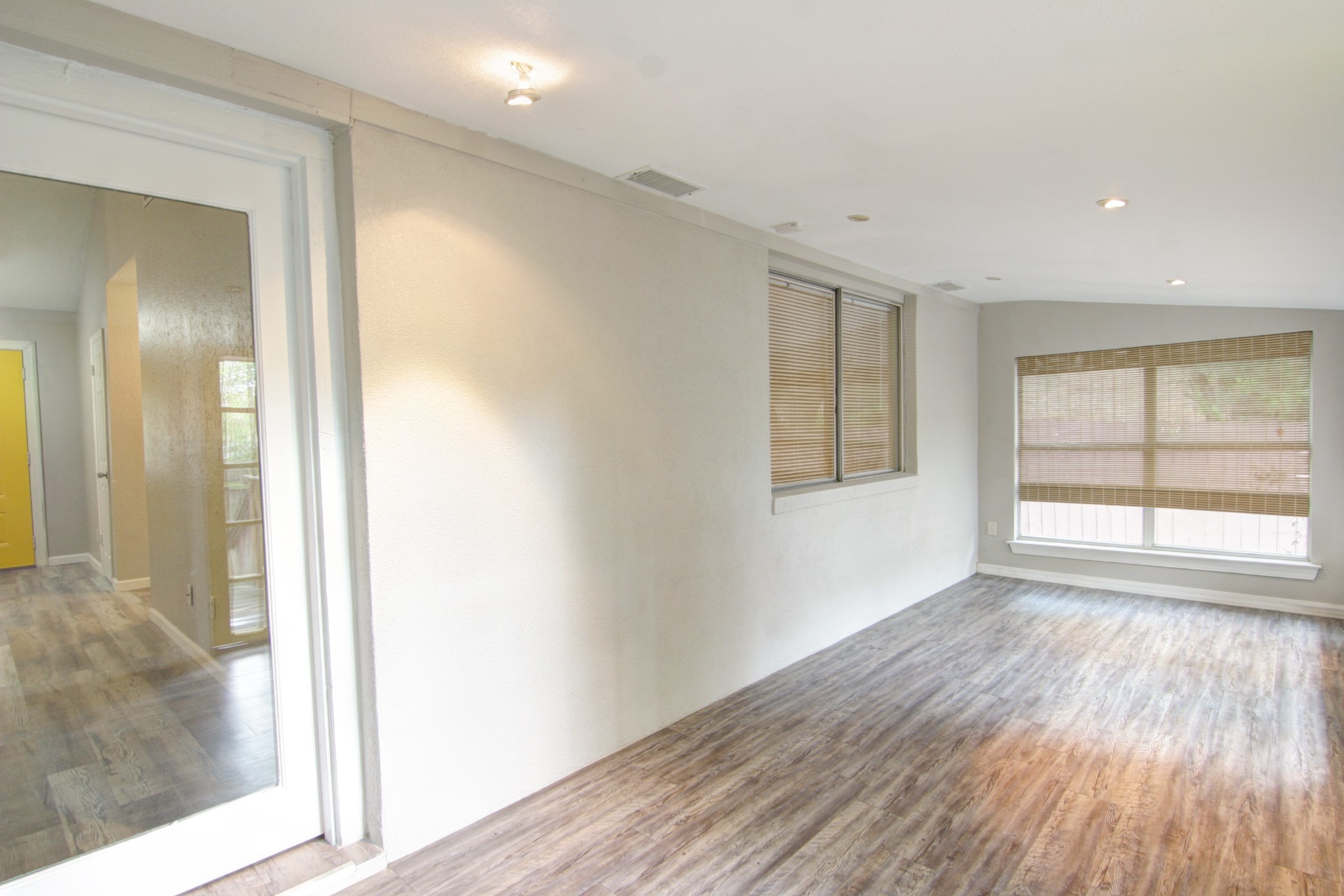 908 Echo Lane Austin, TX 78745 - Photo 10 of 24 a view of an empty room with wooden floor and a window
