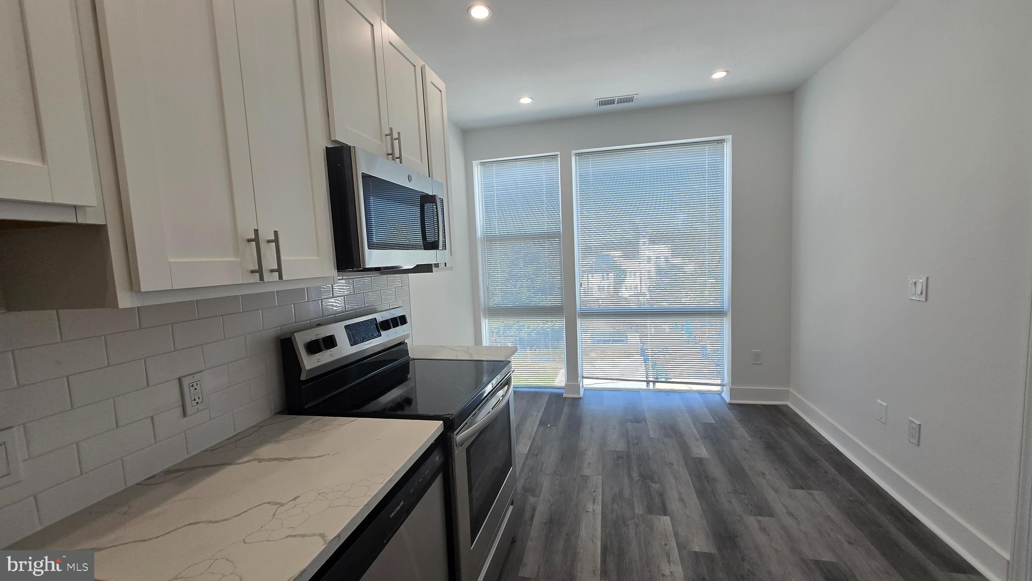 818 Bladensburg Road Northeast, Unit 408 Washington, DC 20002 - Photo 2 of 10 a kitchen with wooden floors and refrigerator