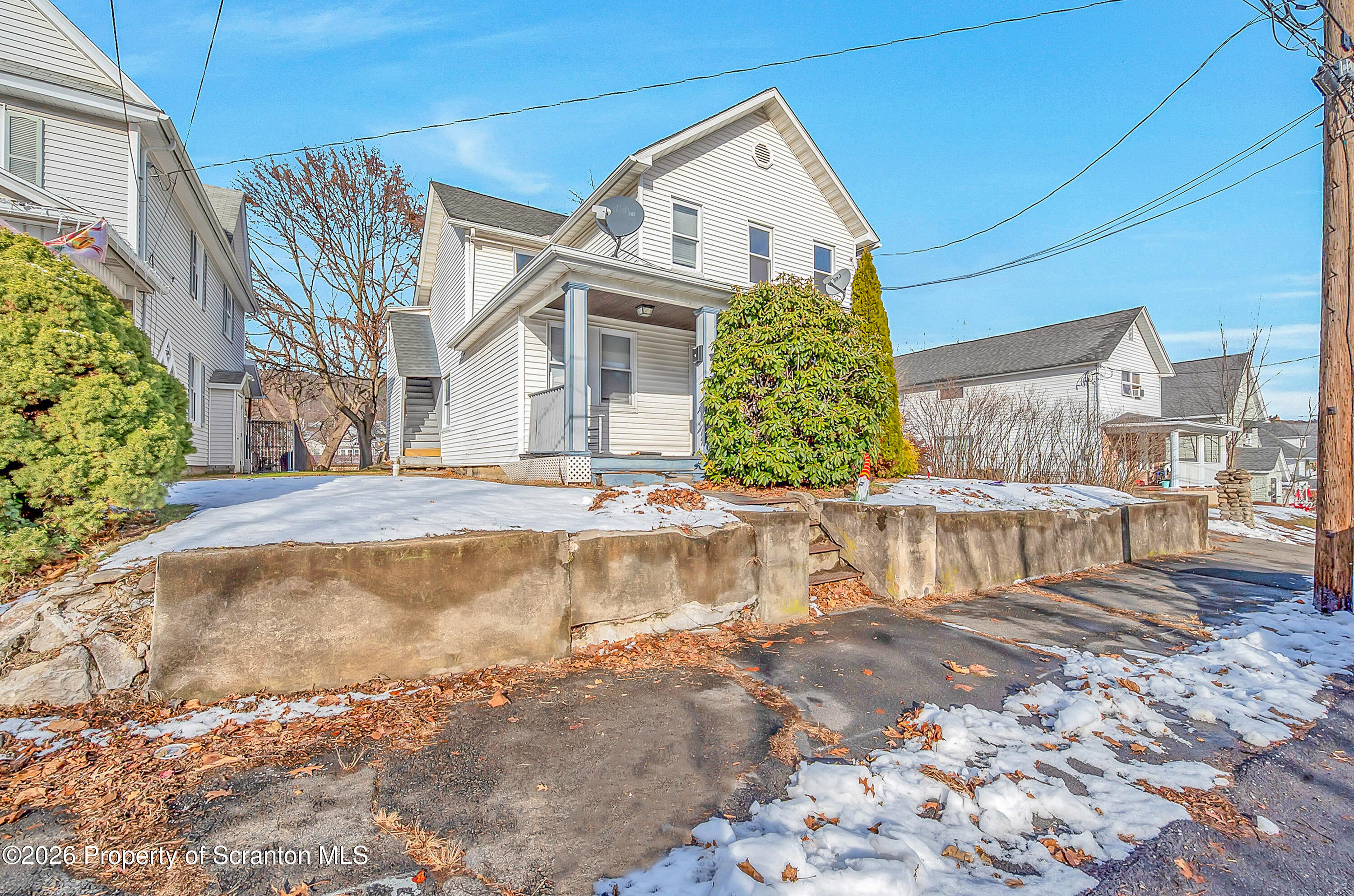 107 2nd Street, Unit 2 Blakely, PA 18447 - Photo 2 of 14 a view of a white house with a yard