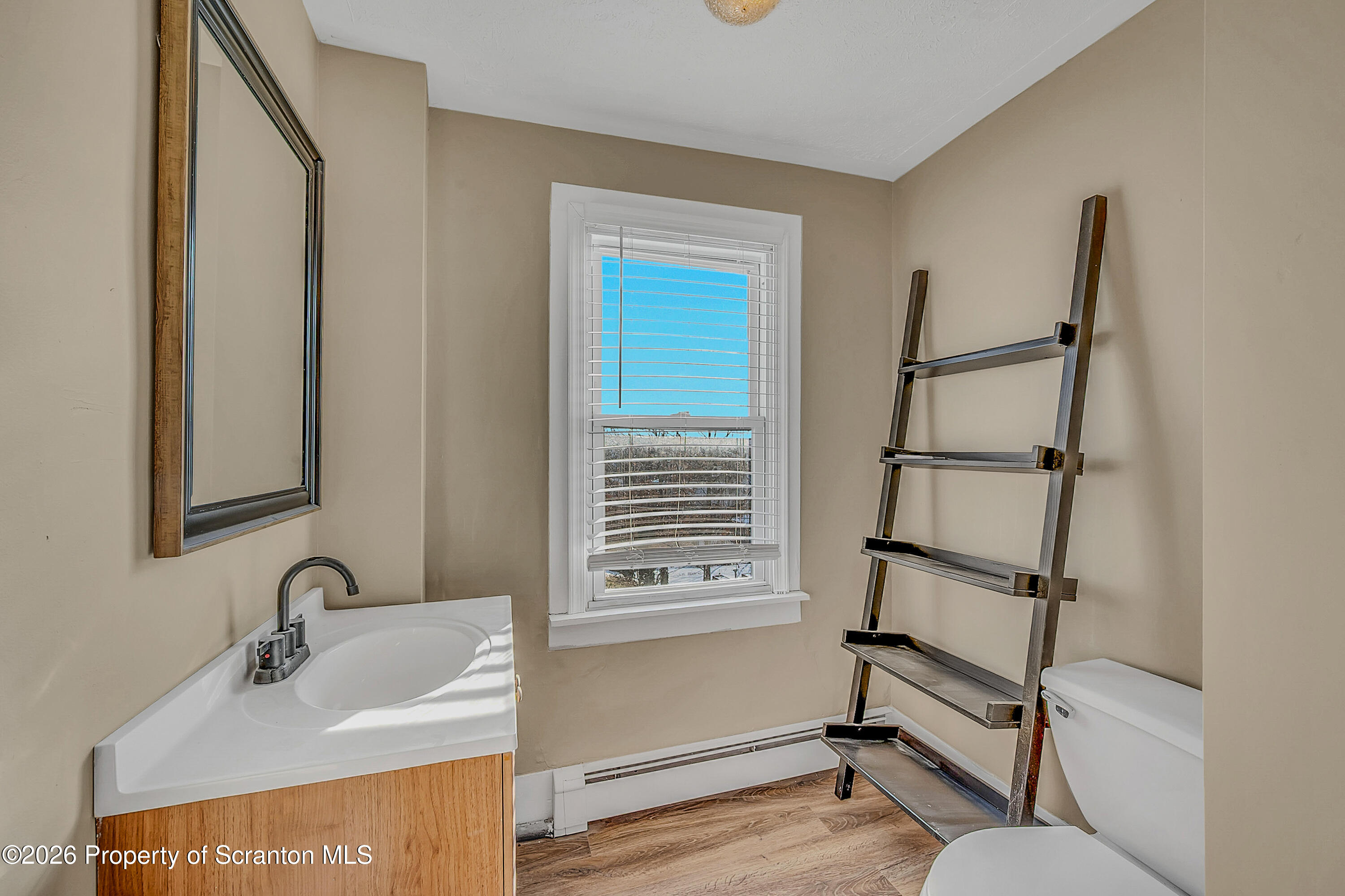 107 2nd Street, Unit 2 Blakely, PA 18447 - Photo 6 of 14 a bathroom with a sink and a mirror
