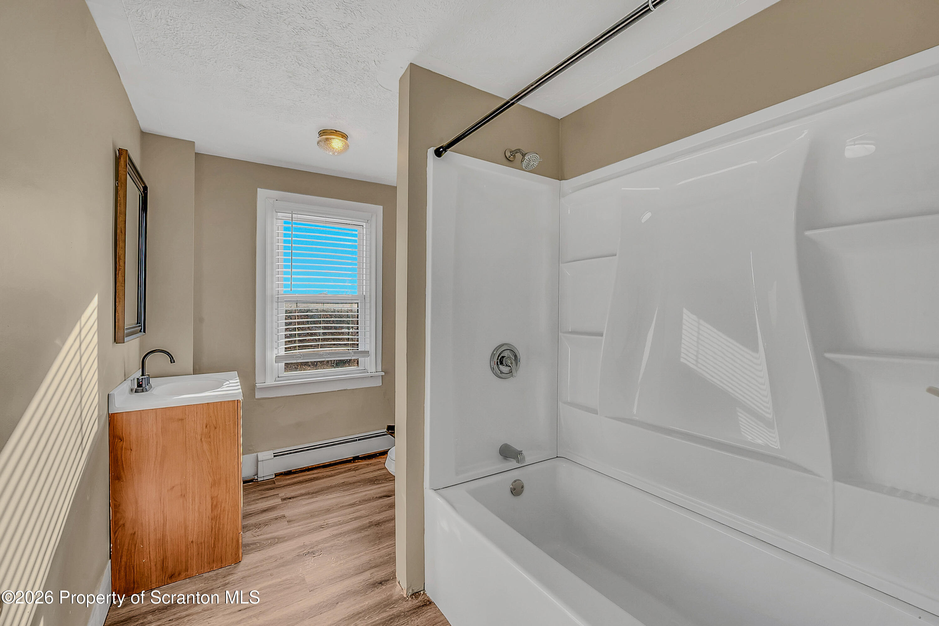 107 2nd Street, Unit 2 Blakely, PA 18447 - Photo 7 of 14 a spacious bathroom with a bathtub and a shower