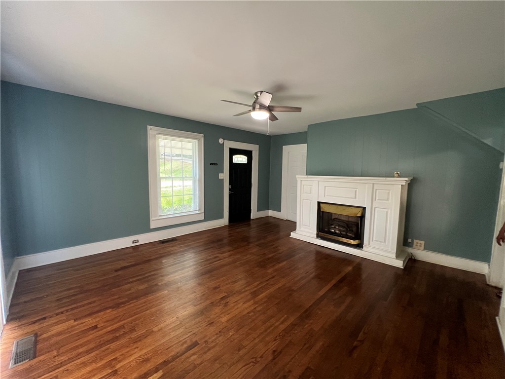 309 Jaynes Street Walhalla, SC 29691 - Photo 2 of 12 Rich hardwood flooring and a classic fireplace create a welcoming living space.
