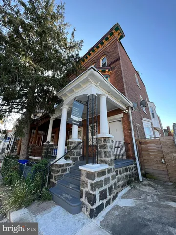 a front view of a house with plants