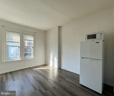 a view of a livingroom with wooden floor and window