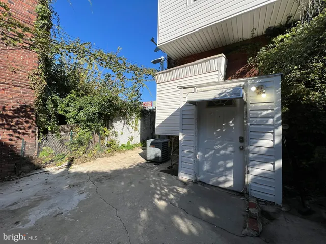 a view of a patio with table and chairs with wooden fence and plants