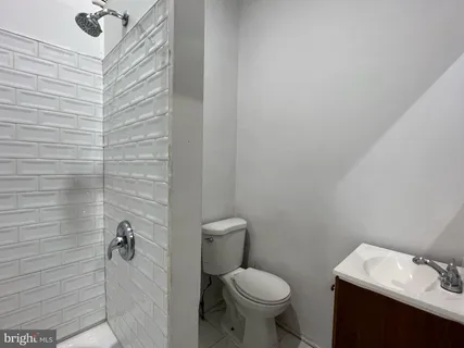 a bathroom with a toilet sink and shower