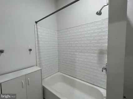 a bathroom with a shower and a sink