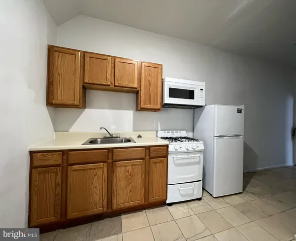 a kitchen with a stove sink and cabinets