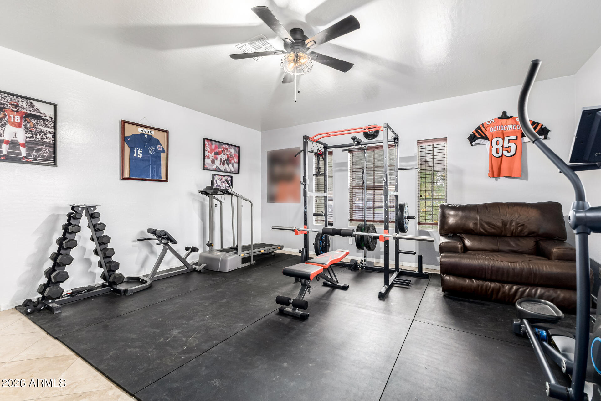 24541 Plum Road Florence, AZ 85132 - Photo 33 of 47 a living room with furniture gym equipment and a chandelier