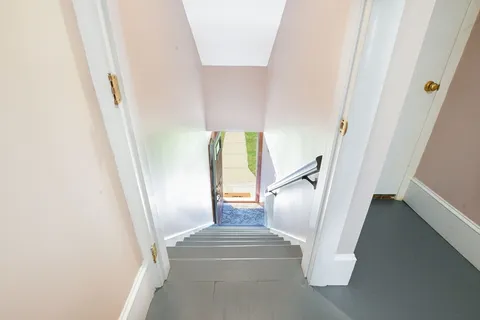 a bathroom with a granite countertop toilet a sink and a mirror