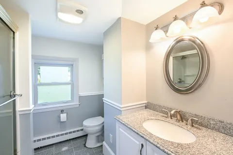 a spacious bedroom with a bed and a window