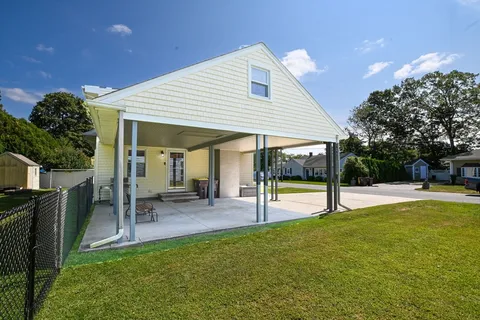 a view of a house with a yard porch and sitting area