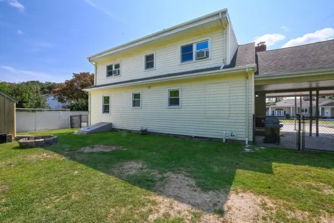 a view of a backyard with plants and a barbeque