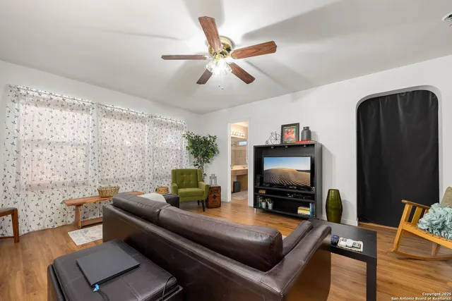a living room with furniture and a flat screen tv
