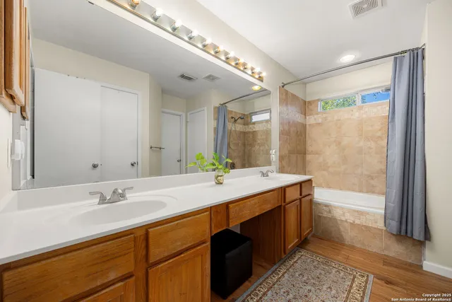 a bathroom with a granite countertop sink mirror and double