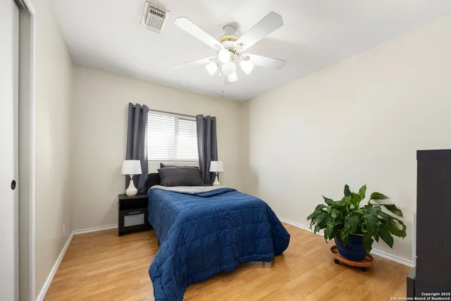 a bedroom with a large bed and a chandelier