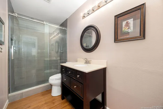 a bathroom with a toilet a sink and a mirror