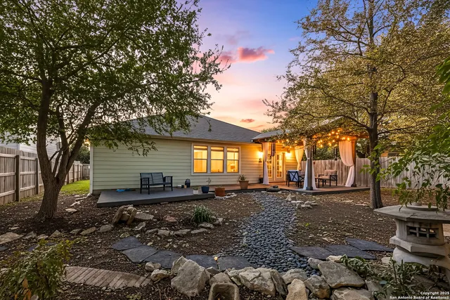 a backyard of a house with barbeque oven table and chairs