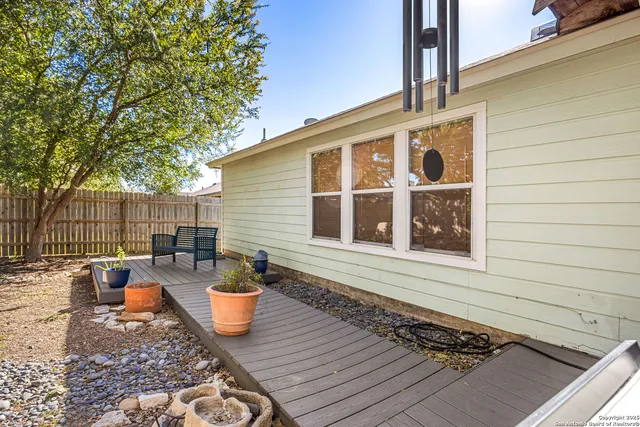 a view of a chairs and table on the wooden deck