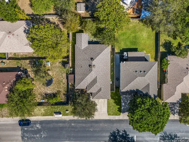 an aerial view of a house with a yard