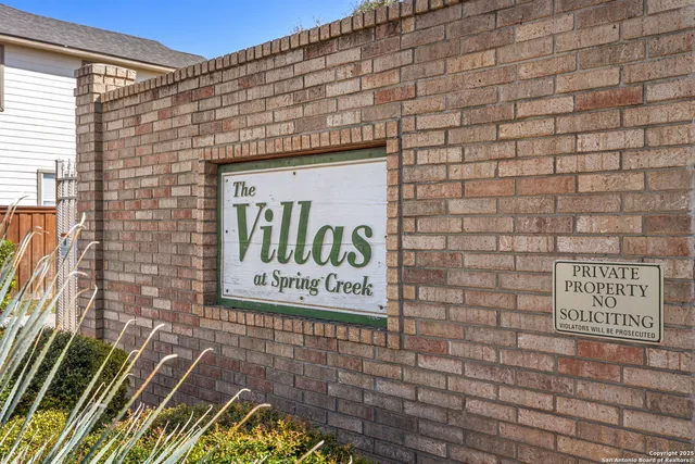 a sign on the brick wall