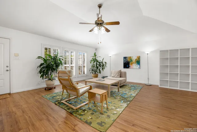 a living room with furniture and a potted plant