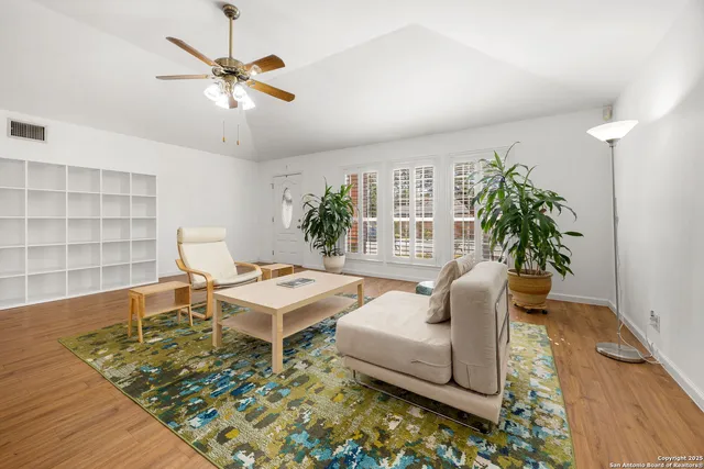 a living room with furniture and a potted plant