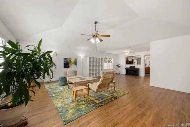 a living room with furniture and a potted plant