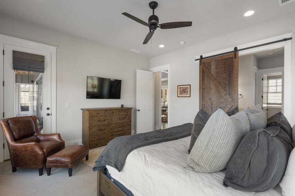 72 Buckeye Ridge Newnan, GA 30263 - Photo 28 of 80 a bedroom with a bed couch and a flat screen tv